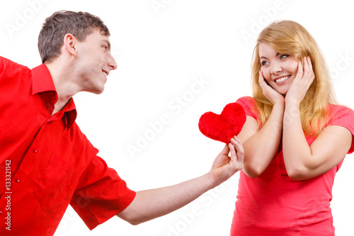 Couple in love. Man giving woman red heart
