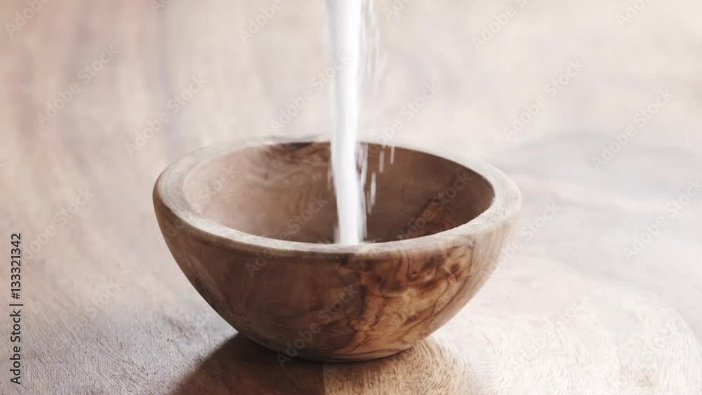 white sugar falling in wood bowl on wooden table in slow motion, 180fps prores footage white sugar falling in wood bowl on wooden table in slow motion, 180fps prores footage