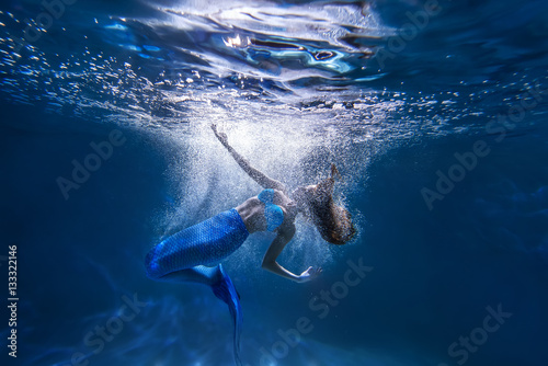 Underwater shot with free diver girl with mermaid tale