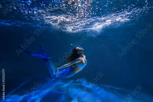 Underwater shot with free-diver girl with mermaid tale