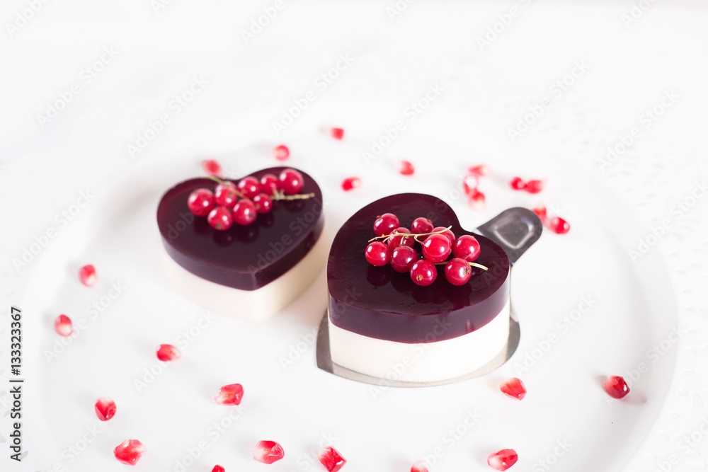 Valentine's cake in heart shape on white background with white decor Valentine's cake in heart shape on white background with white decor