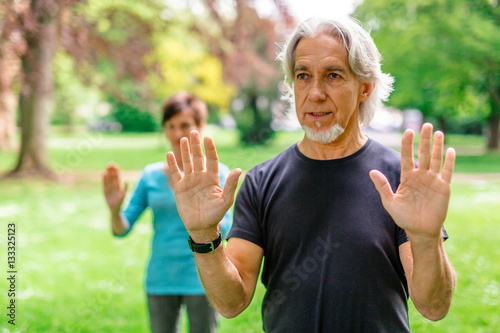 Senior Couple Doing Tai Chi In Park, Tuebingen, Germany