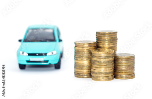 Coins stack with a blue model car and Financial statement. Loan finance concept.