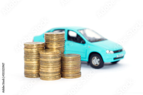 Coins stack with a blue model car and Financial statement. Loan finance concept.