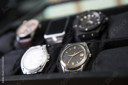 Beautiful leather and steel watches in a watch box.