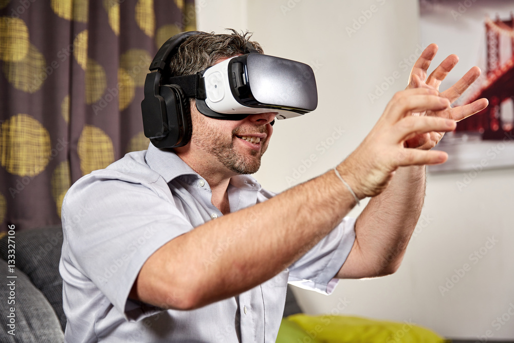 Man with vr virtual reality headset grabbing with hands Man with vr virtual reality headset grabbing with hands