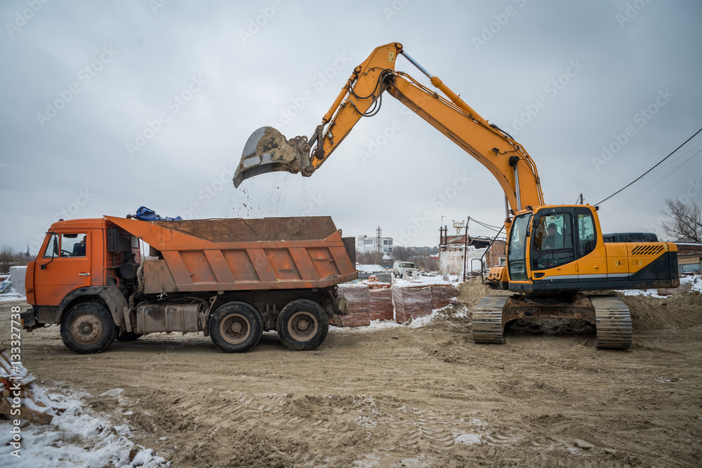 the tractor and the heavy truck behind work on a construction object the tractor and the heavy truck behind work on a construction object