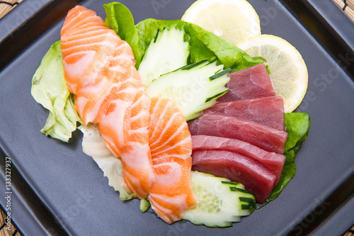 tuna and salmon sashimi on black dish