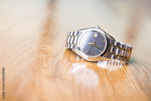 Men's luxury wrist watches on wooden table.