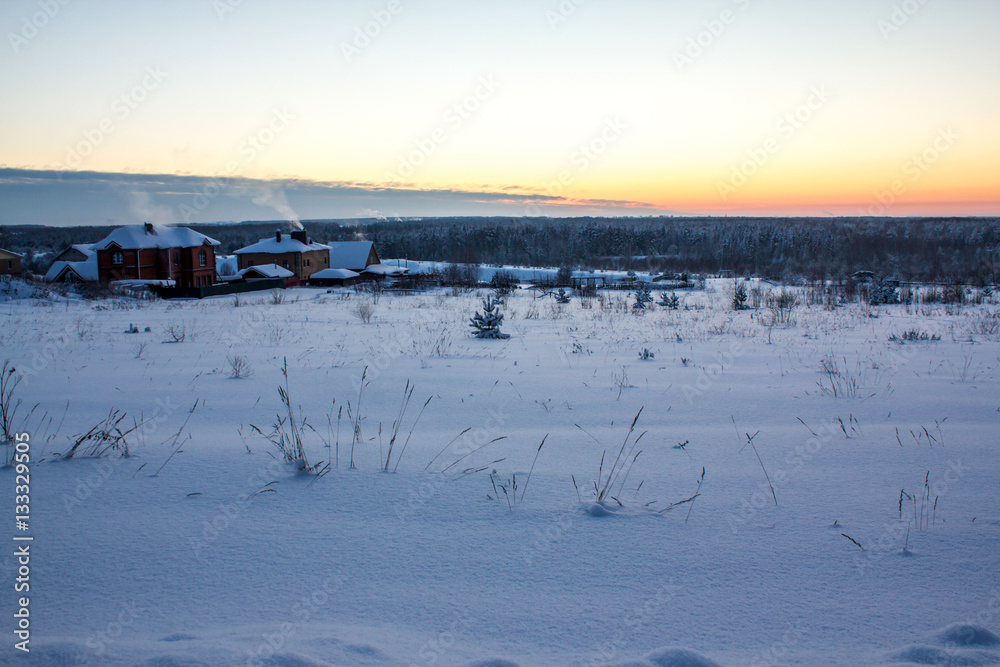 rustic cabins nestled in snow on a cold winter evening