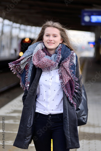 Young woman on a train station.