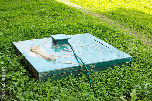 green cap of autonomous sewage in grass