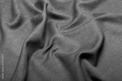 Texture of black fabric put by waves.