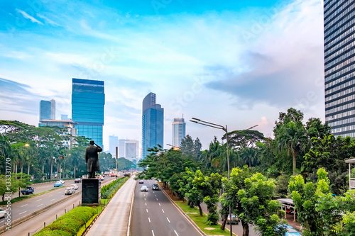 View of  modern skyscraper buildings behind general Soedirman statue. In the central business area in Sudirman street, Jakarta, Indonesia