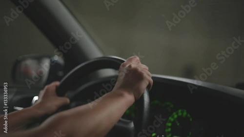 Woman driving her car in a highway tunnel, having her hands on the steering wheel photo