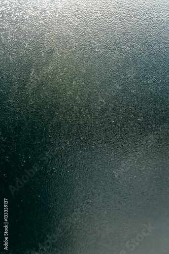 Blurry abstract closeup of foggy condensation on window glass background