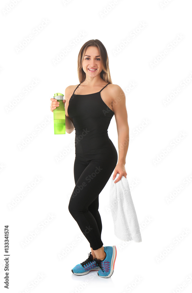 Sporty young woman with towel and bottle of water on white background Sporty young woman with towel and bottle of water on white background