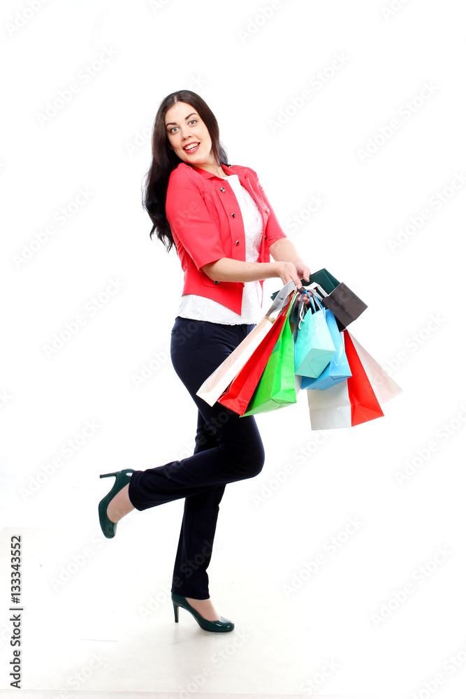 Studio shot of an attractive young woman holding shopping bags. Studio shot of an attractive young woman holding shopping bags.