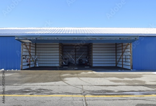 open empty aircraft hangar door lifted up