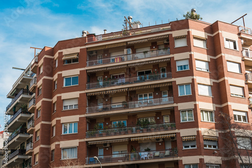 red brick apartment building with big balconies