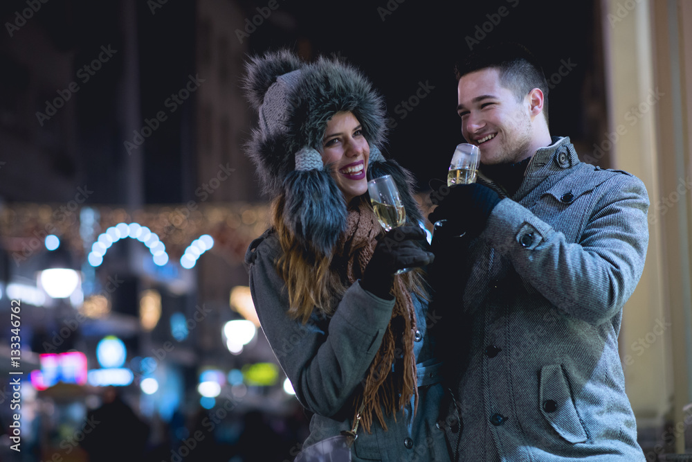 Obraz premium Young lovers enjoy on the street at night in the city, the street lights, romance.Under exposed photo