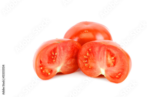 fresh whole tomato and half cut tomato on white background