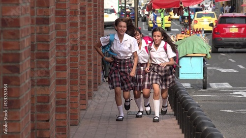 Female Students Running On Sidewalk