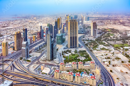 Aerial panoramic view of a big futuristic city Dubai from pinnacle of Bufj Khalifa skyscraper. Business bay, Dubai, United Arab Emirates. Skyline, skyscrapers of down town business center.