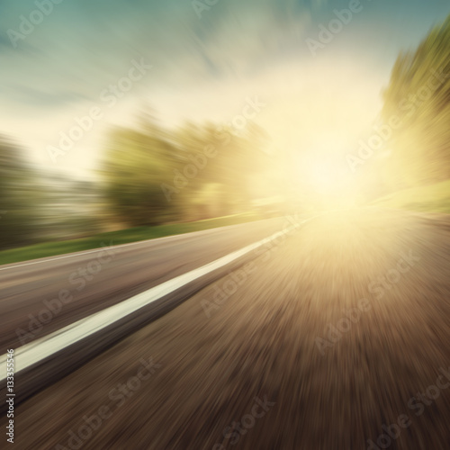 Grunge image of motion blurred road.