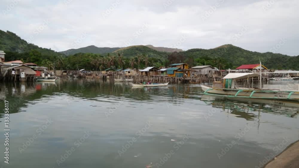 in coron philippines the antique stilts house for poor people dirty and boat near water. in coron philippines the antique stilts house for poor people dirty and boat near water.