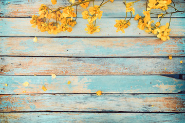 Yellow flowers on vintage wooden background, border design. vintage color tone - concept flower of spring or summer background