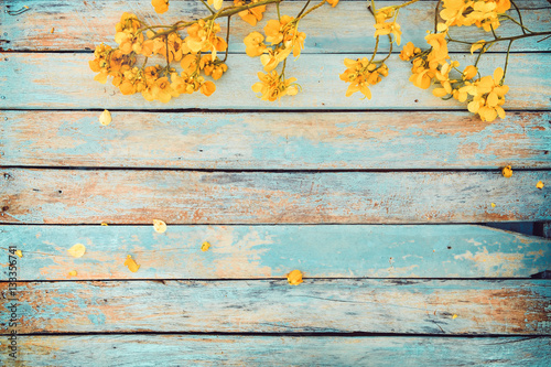 Yellow flowers on vintage wooden background, border design. vintage color tone - concept flower of spring or summer background