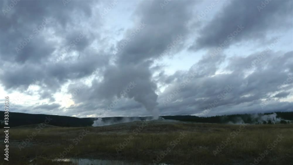Timelapse of old faithful geyser erupting, at a cloudy evening, at yellowstone national park, in Wyoming, United states of America