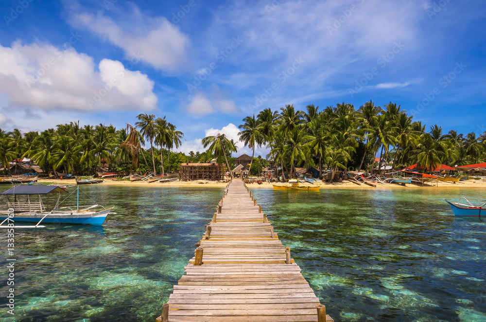 Obraz premium Wooden Dock and Fishing Village Landscape With Tide Pools and Palm Trees - Siargao Island, Mindanao - Philippines