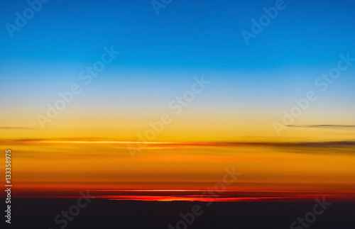 An amazing sunset over earth through a window of a plane, background