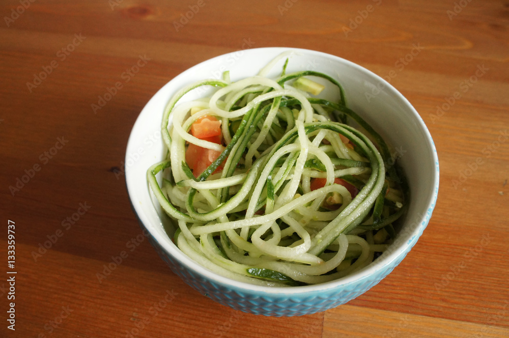 Raw cucumber green vegetable spaghetti in bowl