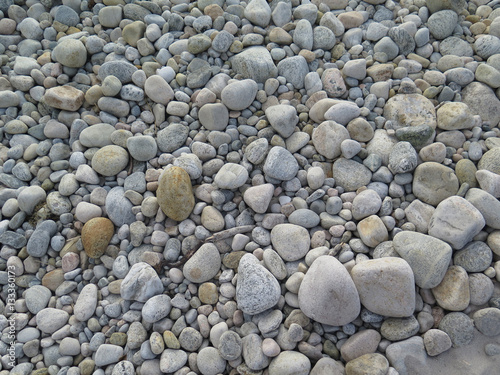 Worn smooth grey rocks along the seashore
