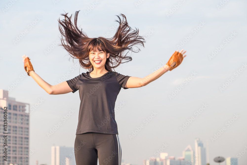 Sports young woman stand on top of building Sports young woman stand on top of building