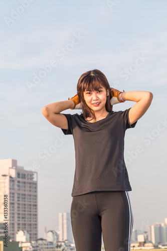 Sports young woman stand on top of building