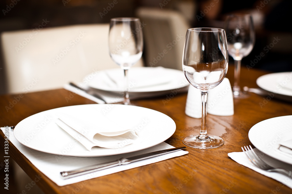 Empty wine glasses on a served table in a fancy restaurant