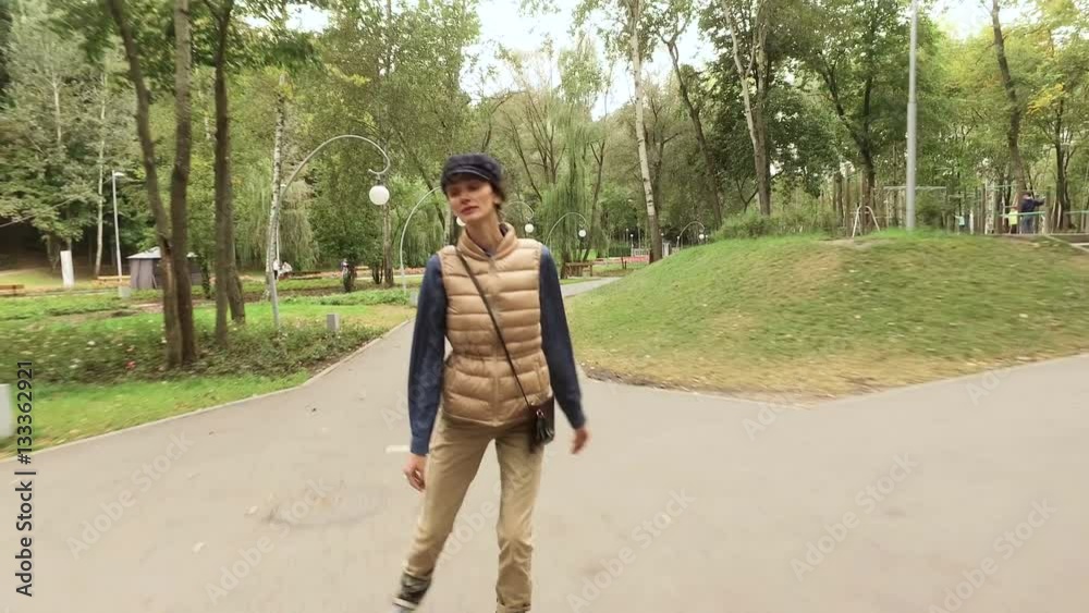 Roller skates. Female roller-skater practicing inline skating in the autumn park. 4K