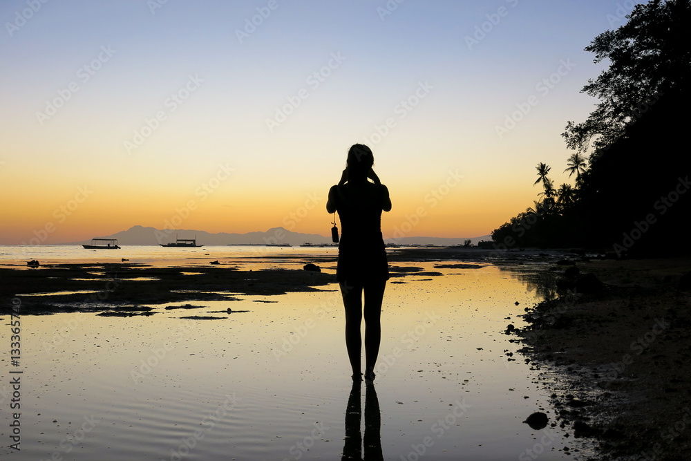 Woman Taking Sunset Pictures on Beach