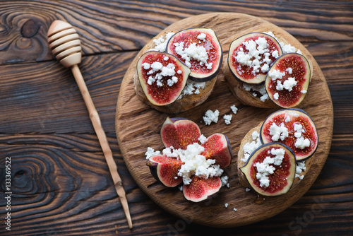 Bruschetta with fig fruits and cheese in a rustic wooden setting