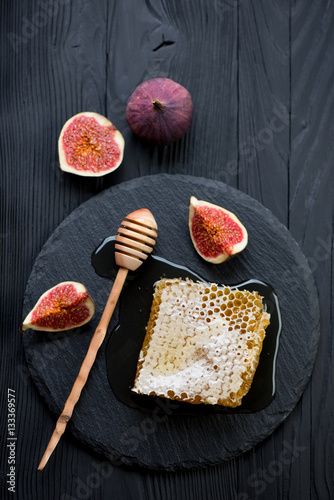 Stone slate with honey and fresh fig fruits, studio shot