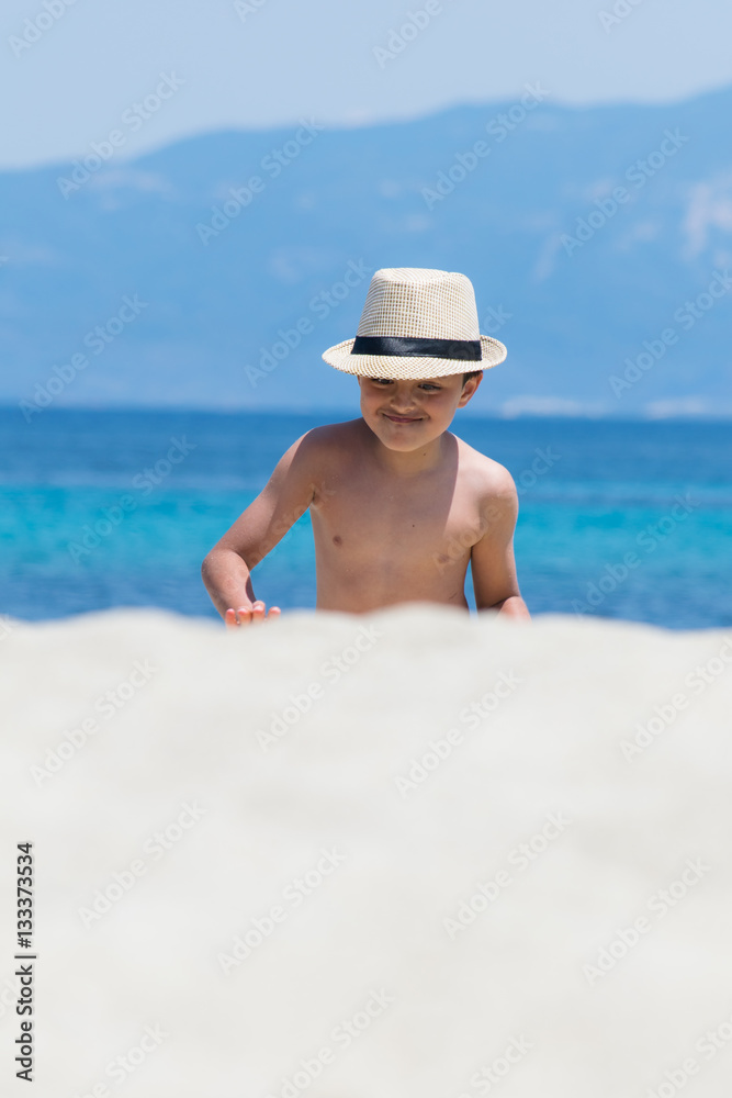 Young boy playing with water pistol by the sea Young boy playing with water pistol by the sea