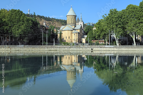 Tbilisi Sioni Cathedral reflected in the water of Kura River in summer morning, Georgia