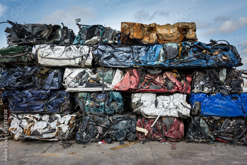 Cars in junkyard,  pressed and packed for recycling.