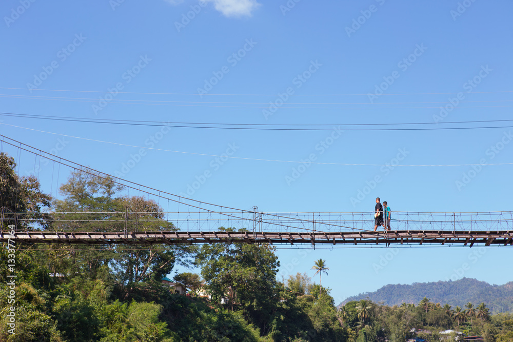 man walking on the bridge