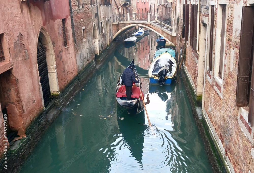 Venetian gondola boat in Venice canal