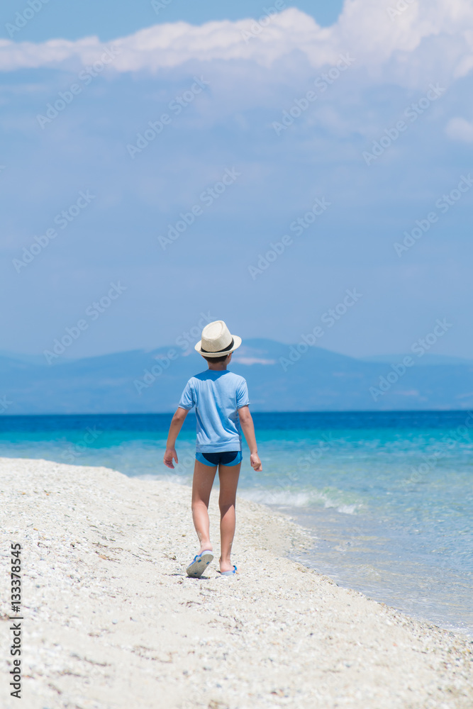 Boy walking on the beach